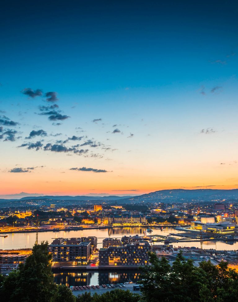 Oslo city lights illuminated under blue chrome dusk sky Norway iStock_000055261494_Large-2